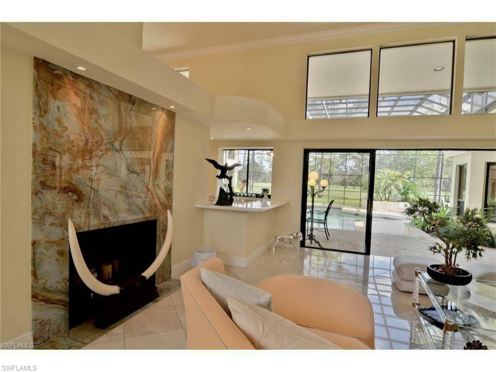 12902 Coco Plum Lane Naples, FL 34119 - Photo 20 of 23 a living room with furniture and a floor to ceiling window