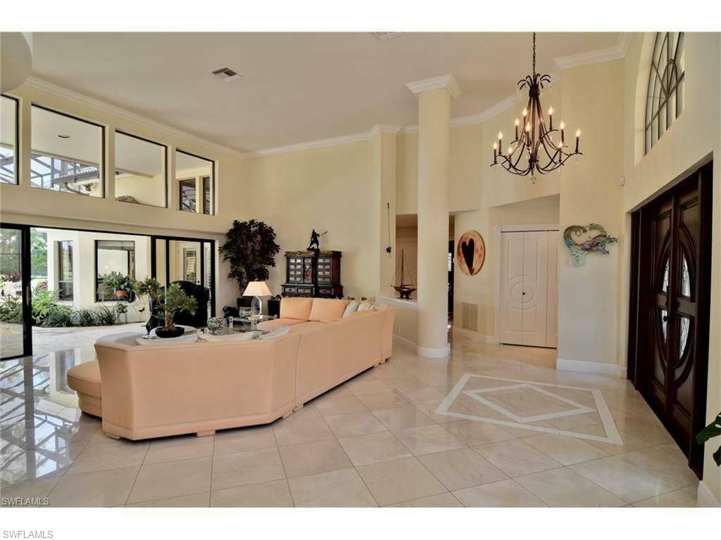 12902 Coco Plum Lane Naples, FL 34119 - Photo 3 of 23 a view of living room with furniture and chandelier
