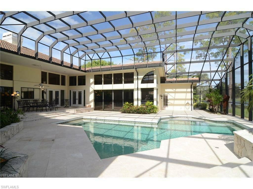 12902 Coco Plum Lane Naples, FL 34119 - Photo 4 of 23 a view of a house with a swimming pool