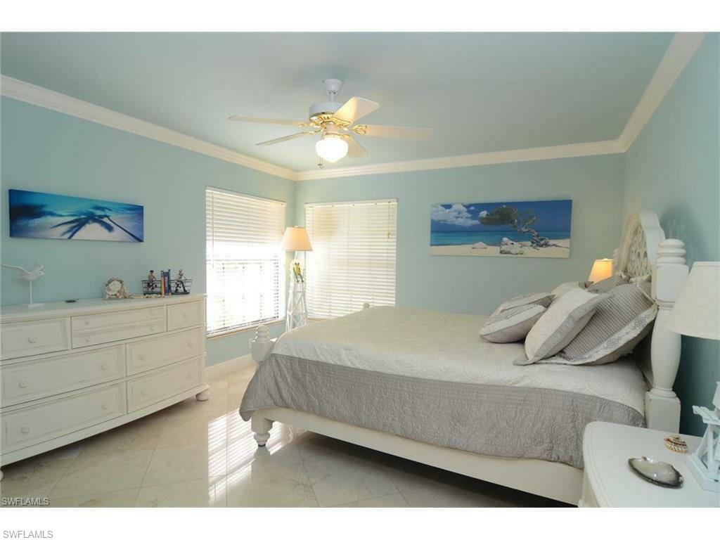 12902 Coco Plum Lane Naples, FL 34119 - Photo 7 of 23 a bedroom with a bed and a window