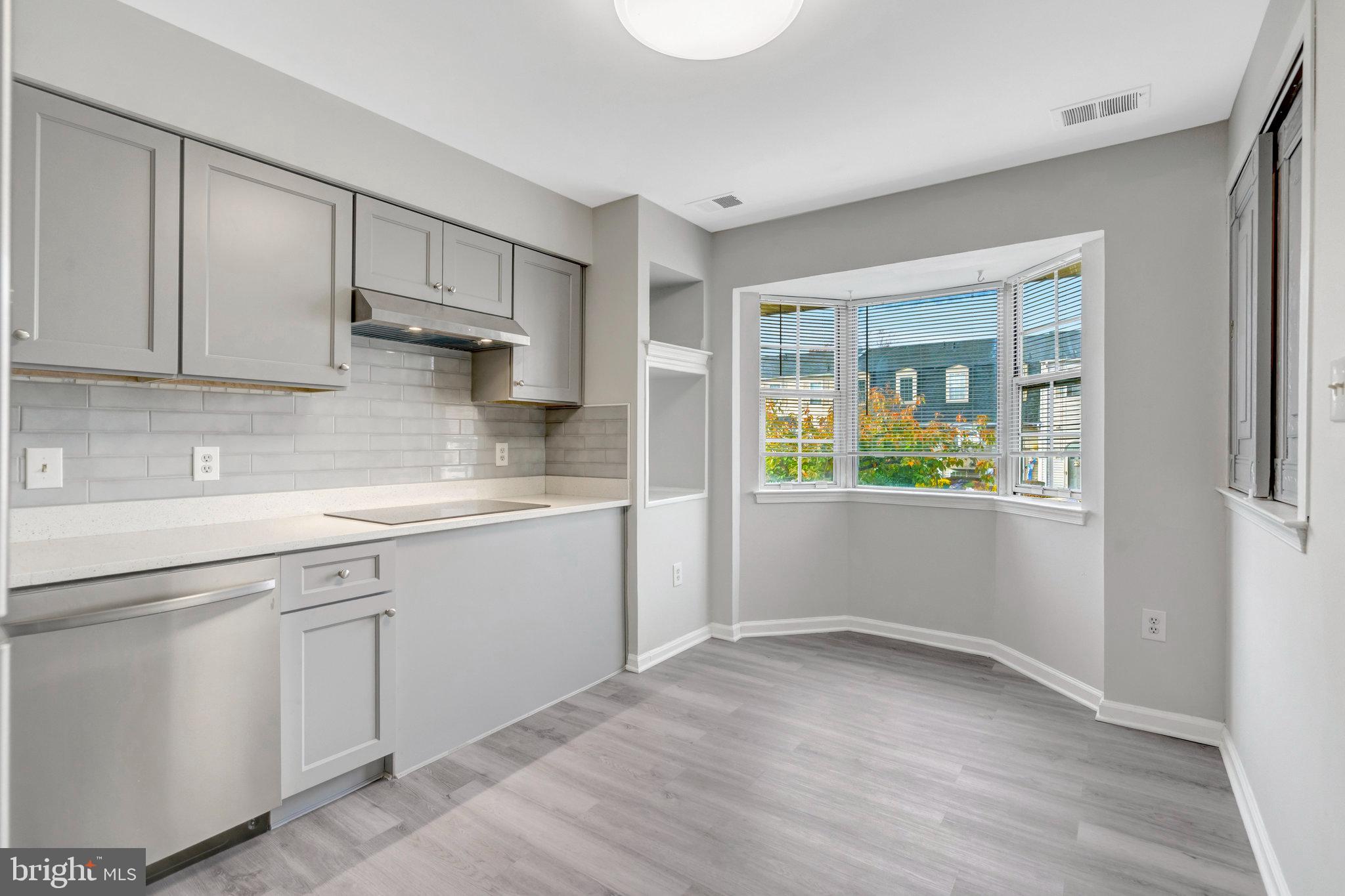 7905 Brighton Way Manassas, VA 20109 - Photo 11 of 32 a kitchen with white cabinets and window
