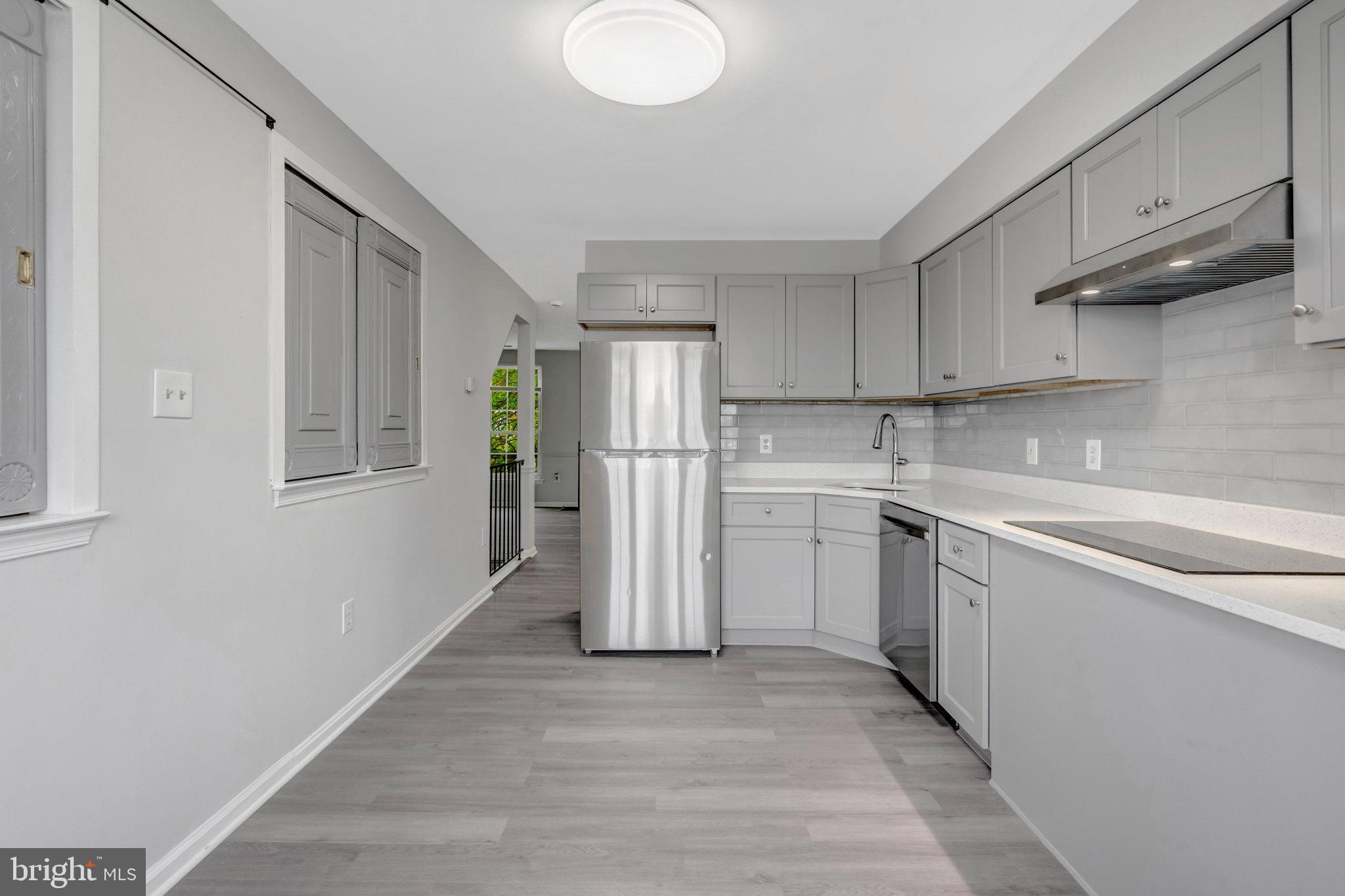 7905 Brighton Way Manassas, VA 20109 - Photo 12 of 32 a kitchen with a sink cabinets stainless steel appliances and a window