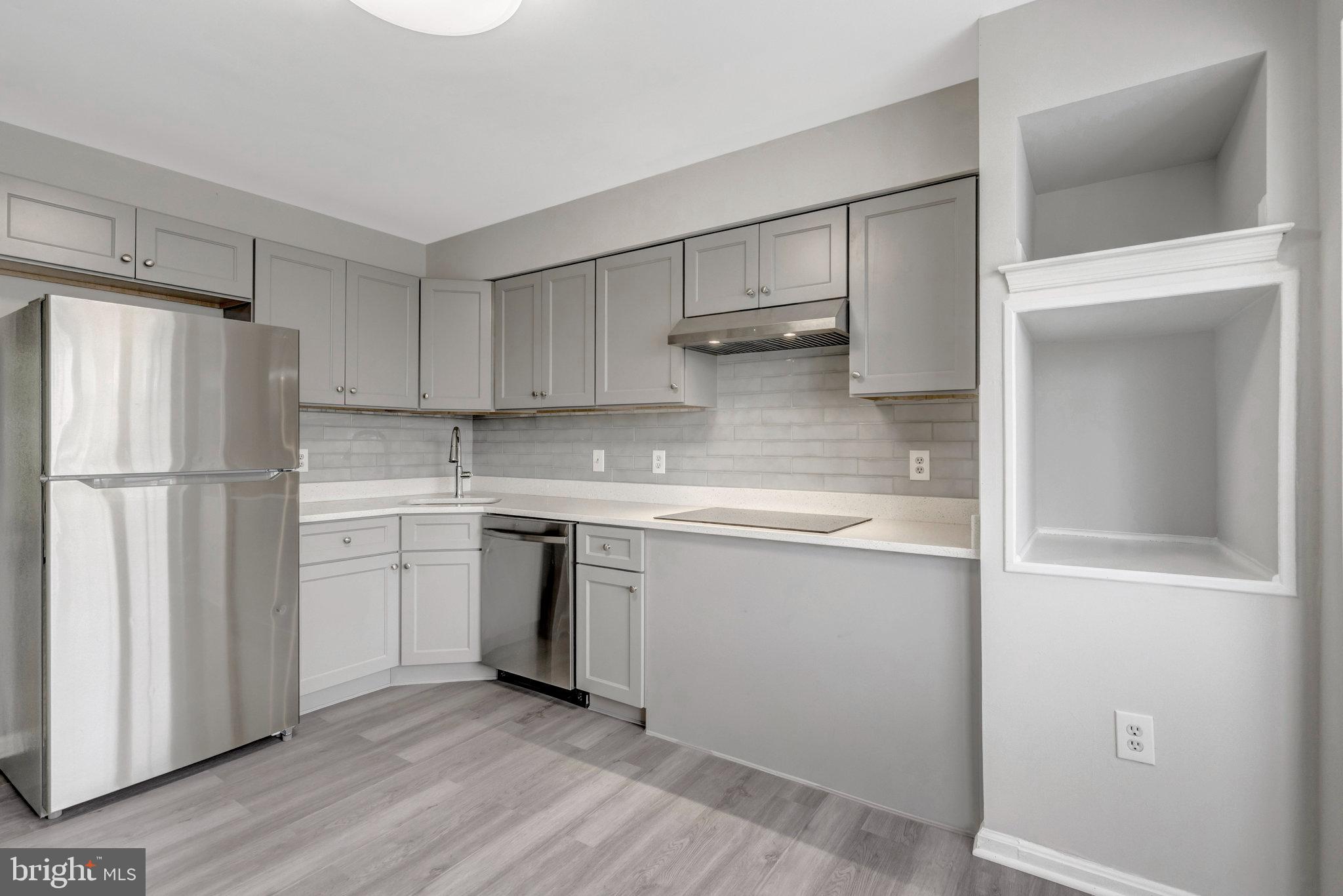 7905 Brighton Way Manassas, VA 20109 - Photo 13 of 32 a kitchen with a refrigerator a sink and a stove top oven