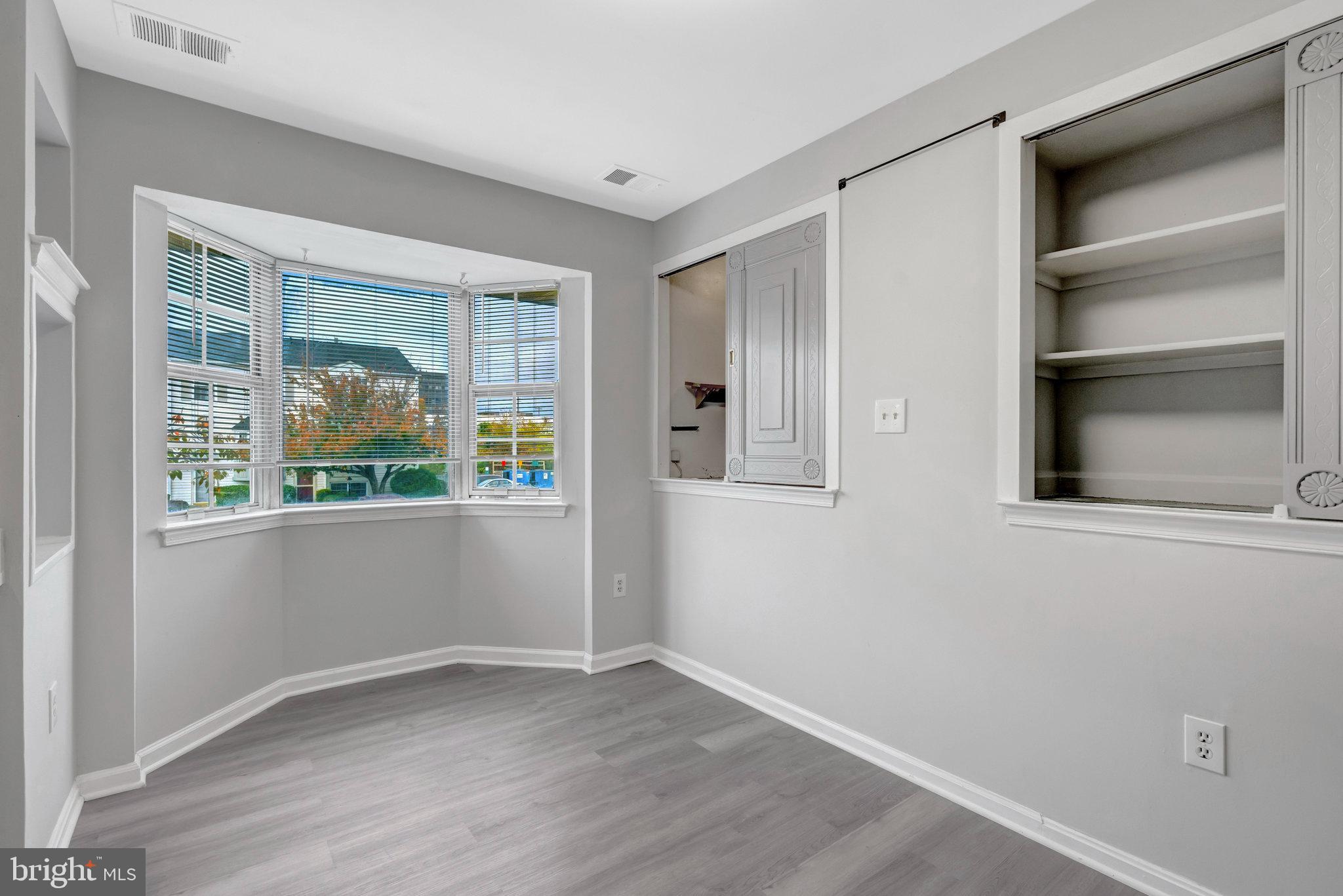 7905 Brighton Way Manassas, VA 20109 - Photo 15 of 32 a view of an empty room with a window and wooden floor