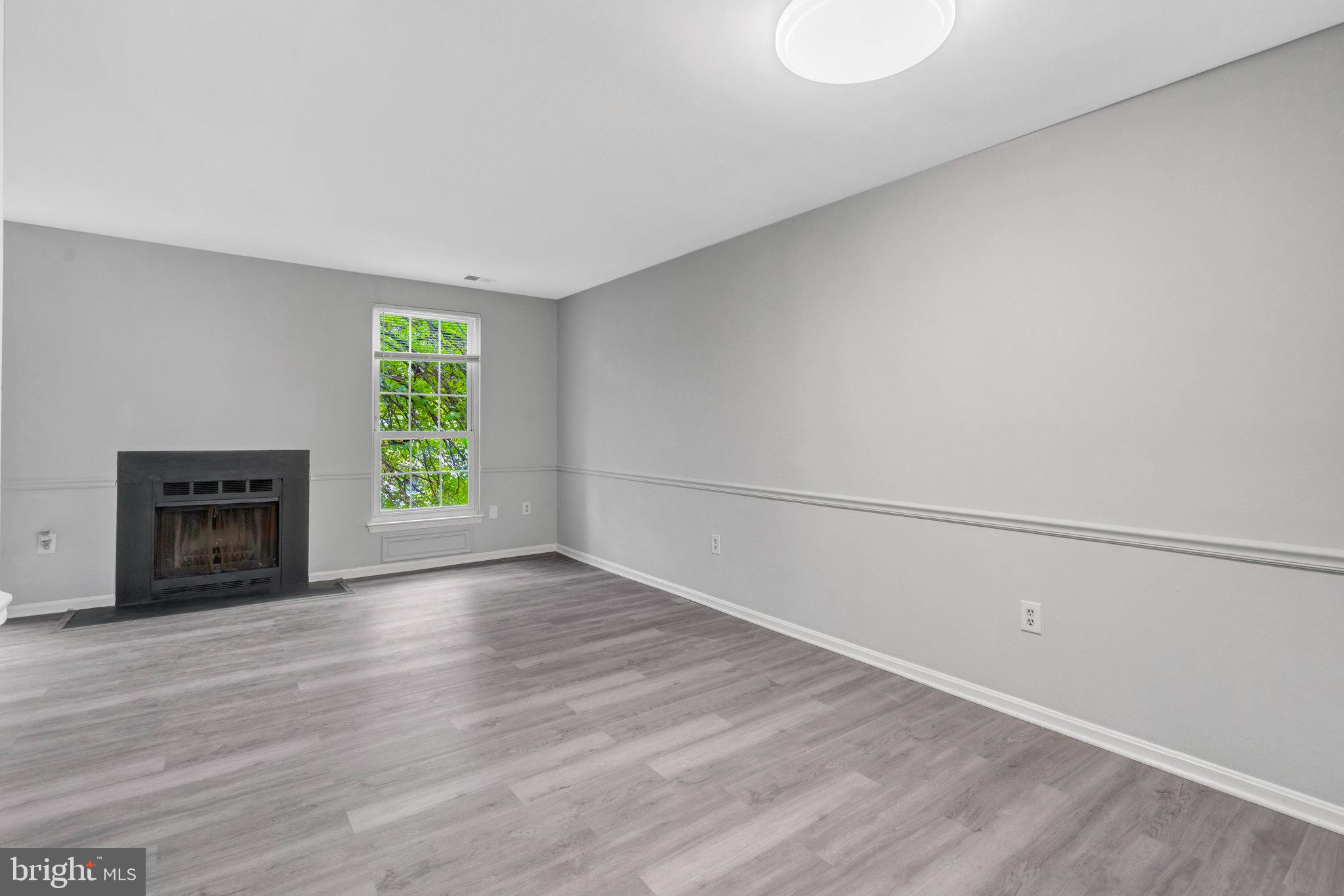 7905 Brighton Way Manassas, VA 20109 - Photo 16 of 32 a view of an empty room with a window and wooden floor