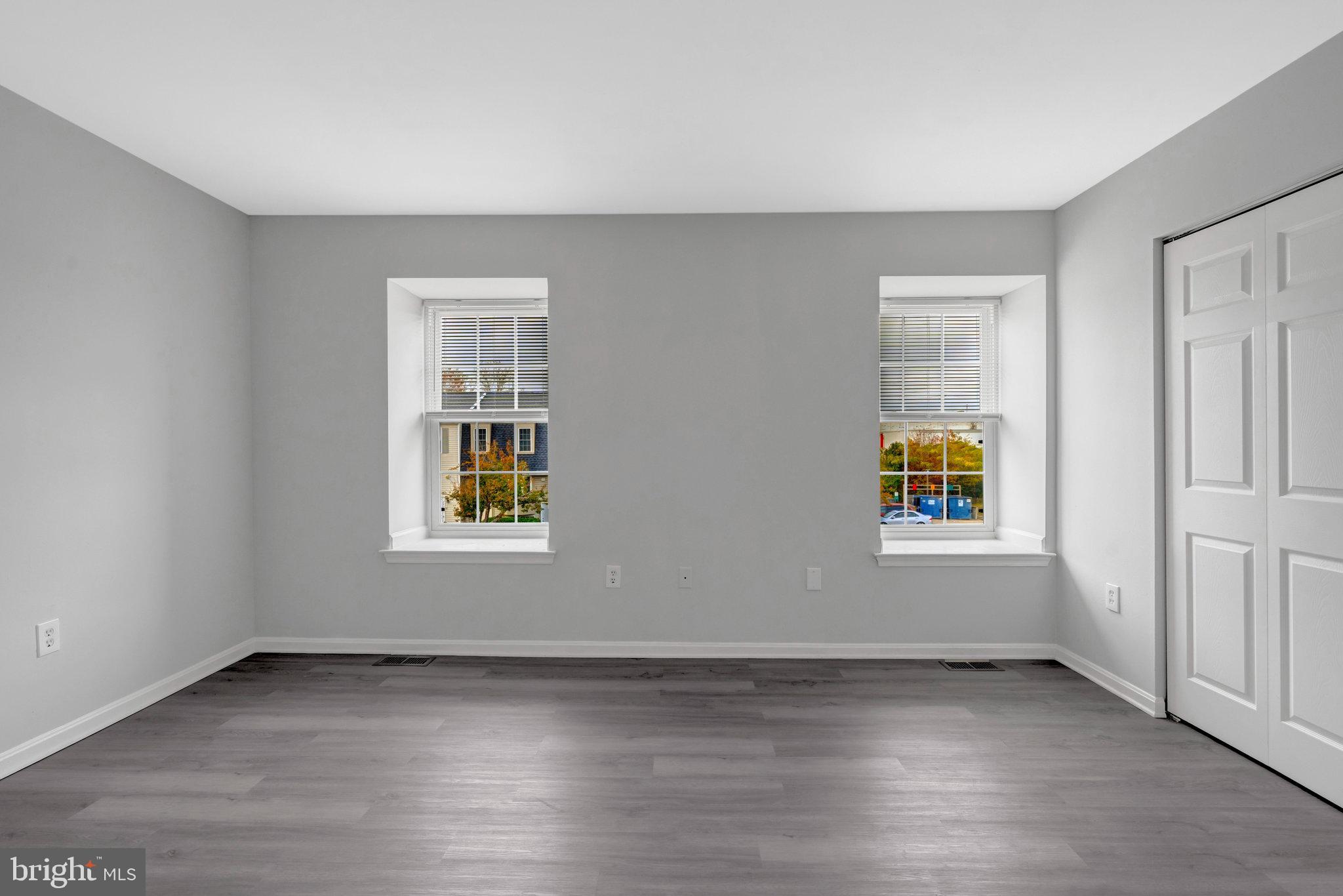 7905 Brighton Way Manassas, VA 20109 - Photo 24 of 32 an empty room with window and wooden floor