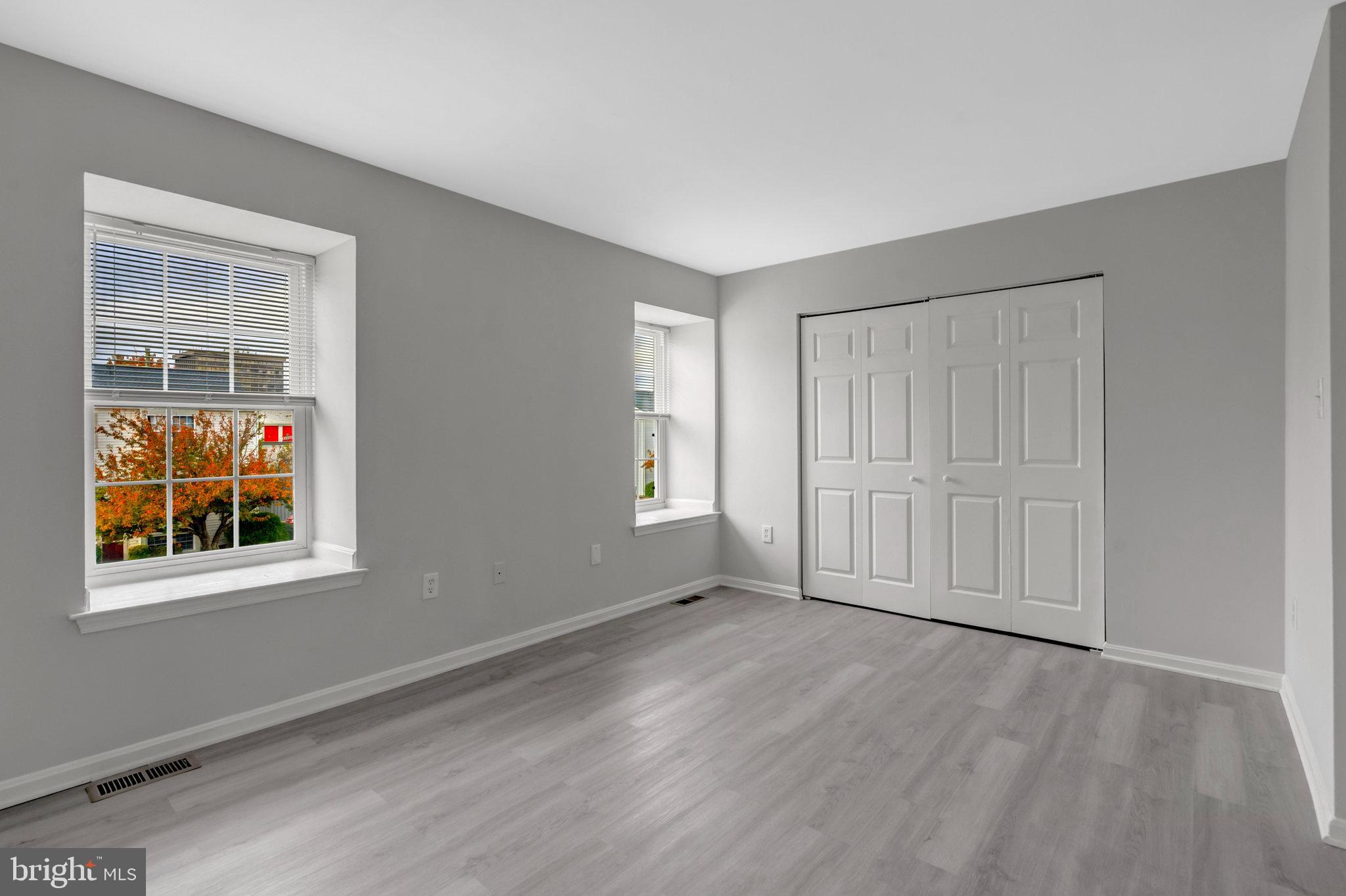 7905 Brighton Way Manassas, VA 20109 - Photo 26 of 32 a view of an empty room with wooden floor and windows