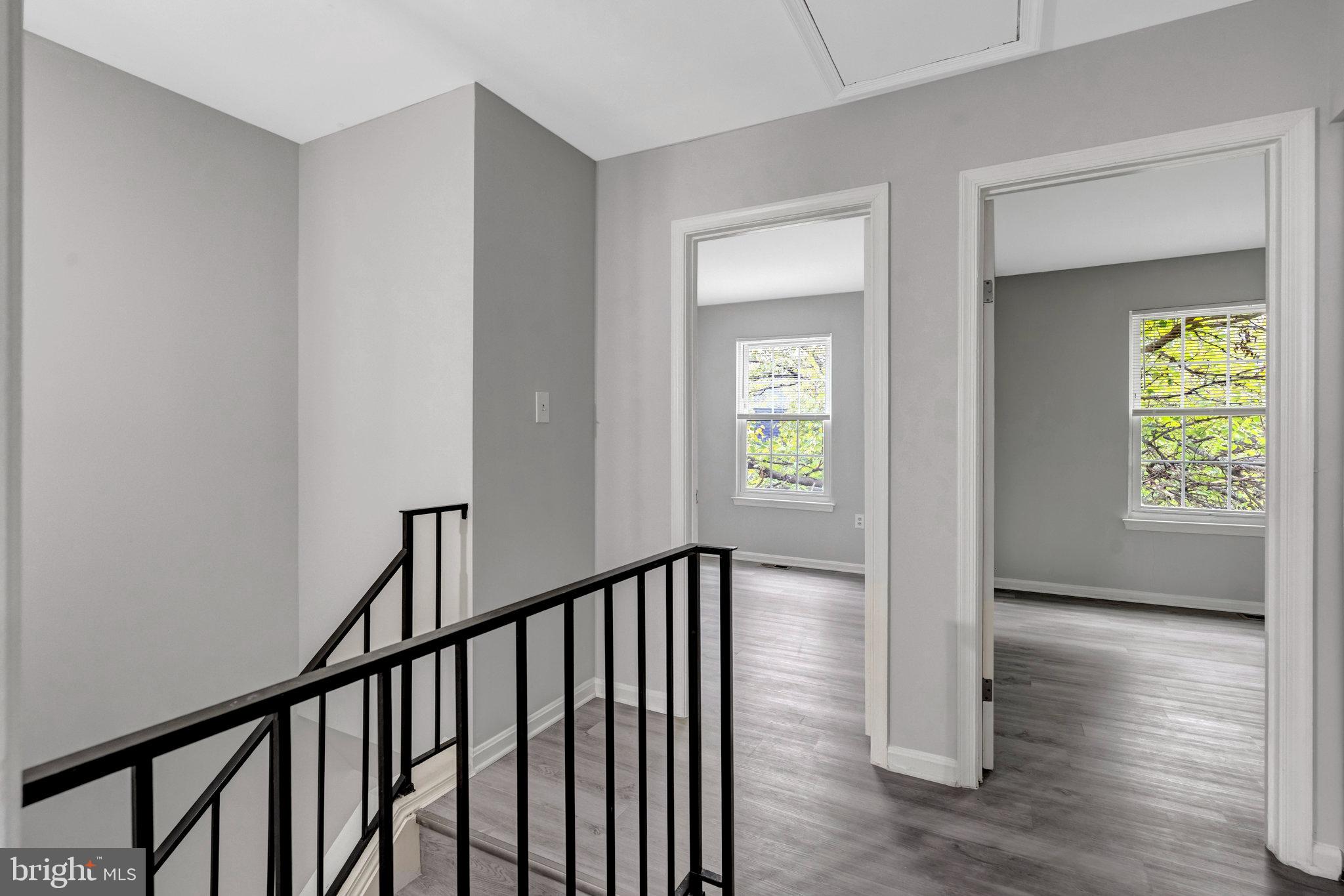 7905 Brighton Way Manassas, VA 20109 - Photo 29 of 32 a view of a hallway with wooden floor and stairs