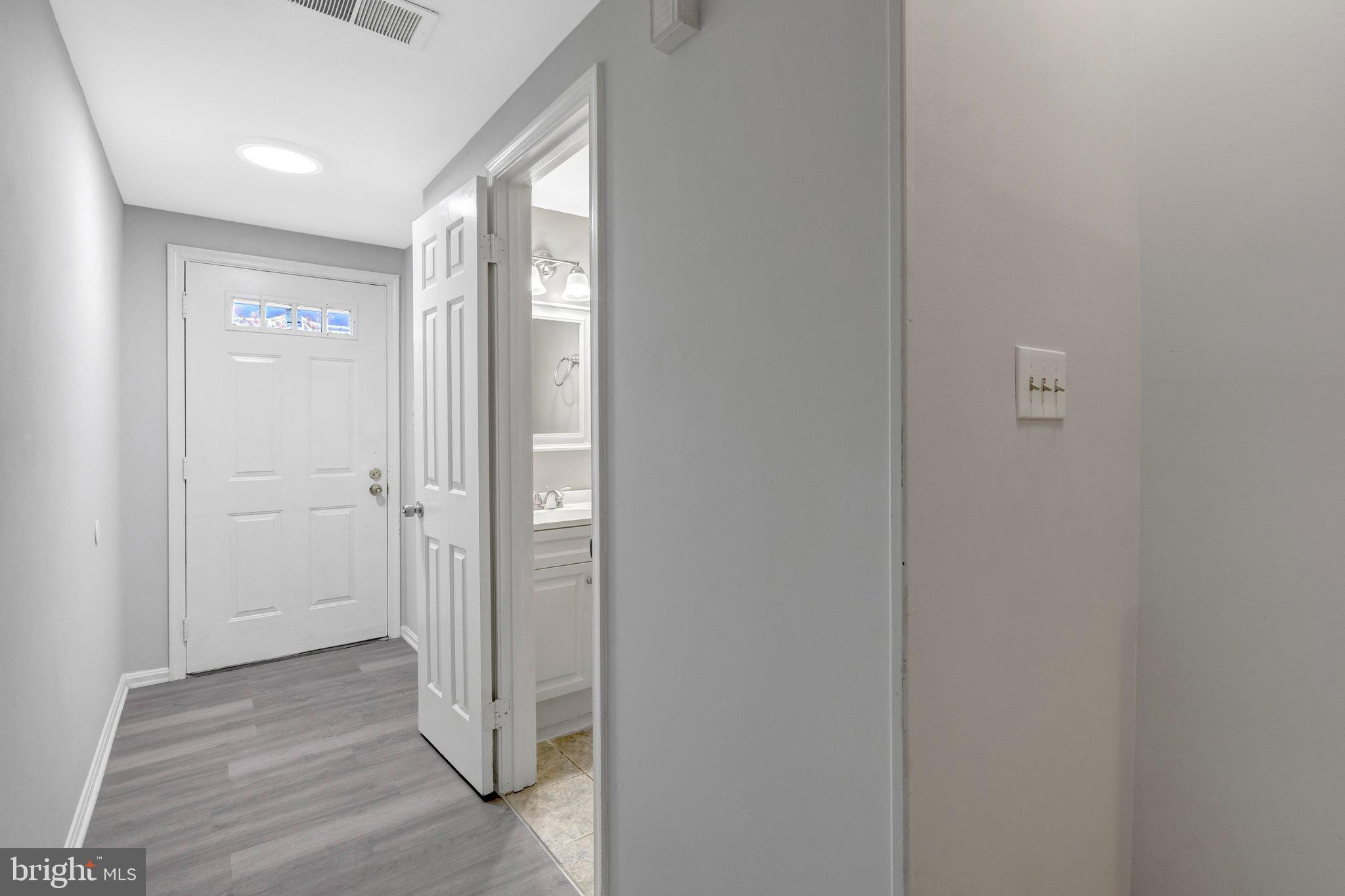 7905 Brighton Way Manassas, VA 20109 - Photo 5 of 32 a view of a hallway with wooden floor