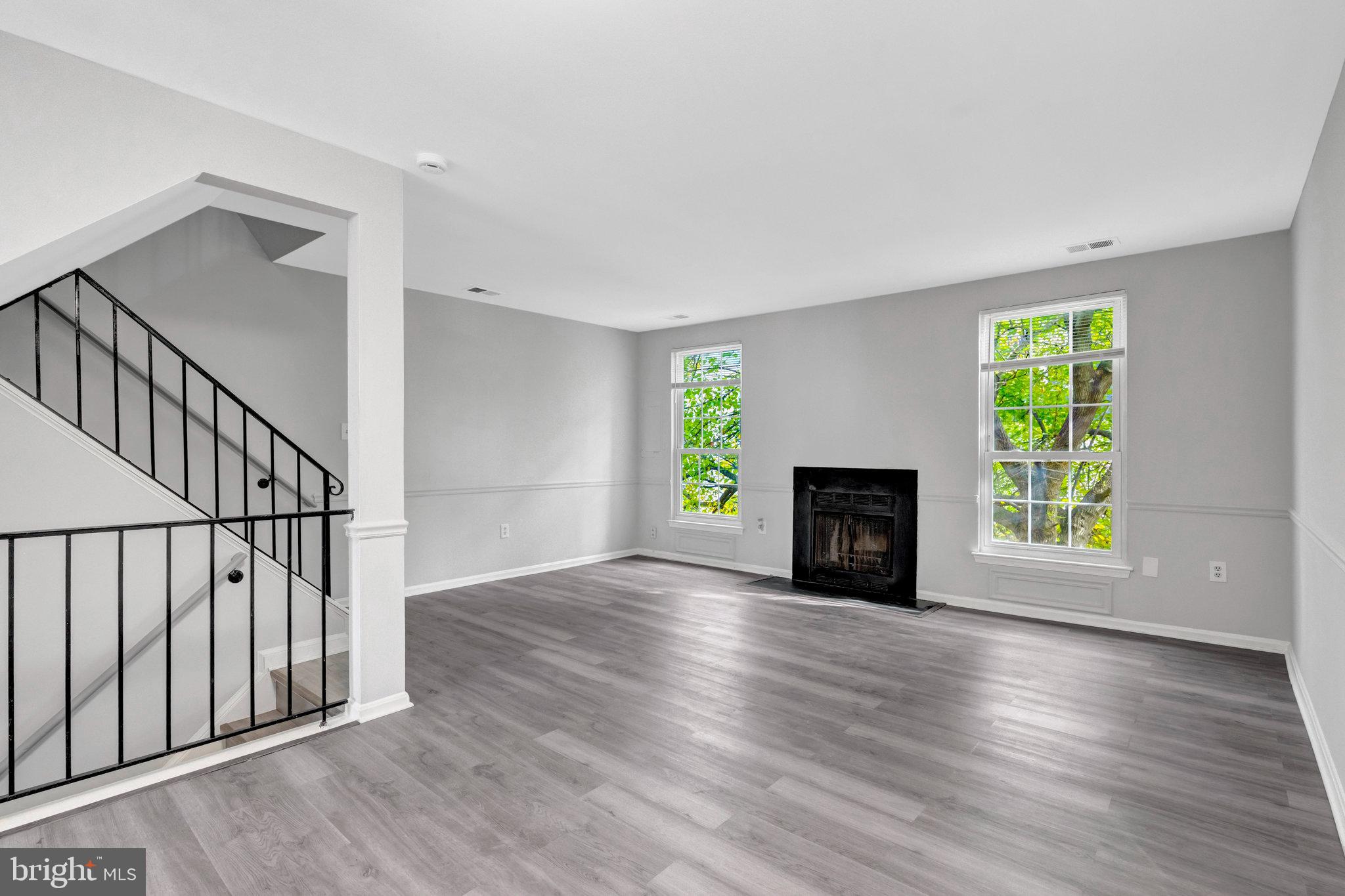7905 Brighton Way Manassas, VA 20109 - Photo 10 of 32 a view of empty room with a fireplace and wooden floor