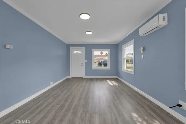 a kitchen with a sink cabinets and wooden floor
