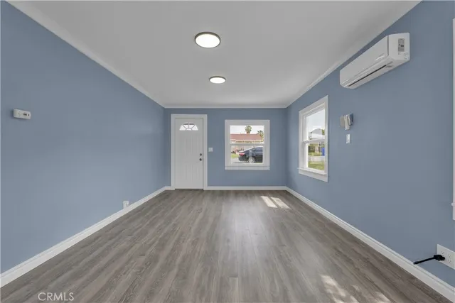 a kitchen with a sink cabinets and wooden floor