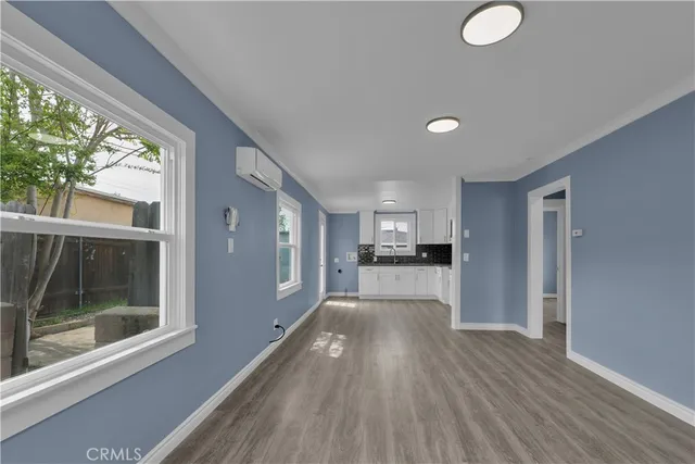 a kitchen with granite countertop a stove a sink and a microwave