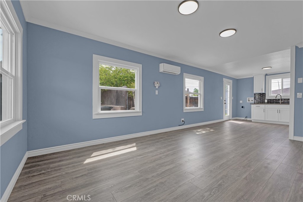 34945 Ave B Yucaipa, CA 92399 - Photo 13 of 69 a view of an empty room with wooden floor and a window