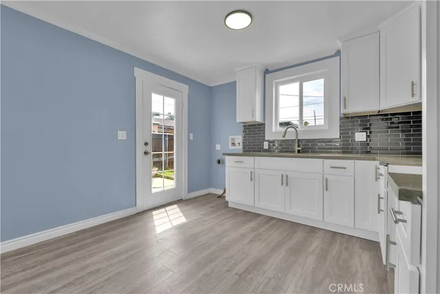 a kitchen with a sink stove and cabinets