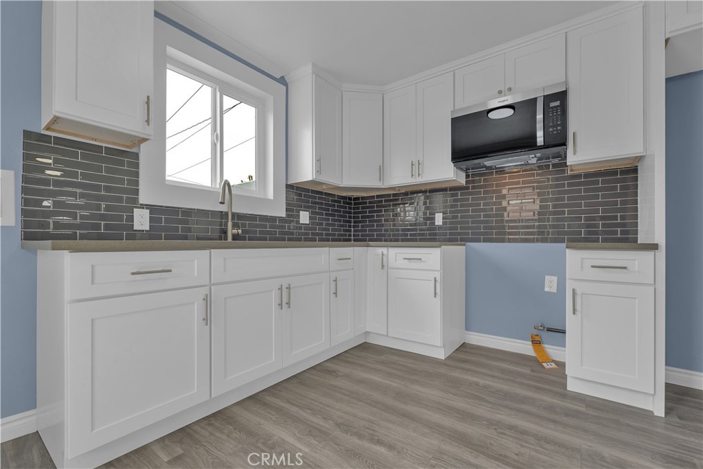 34945 Ave B Yucaipa, CA 92399 - Photo 17 of 69 a kitchen with granite countertop white cabinets and white appliances