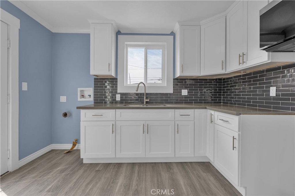34945 Ave B Yucaipa, CA 92399 - Photo 18 of 69 a kitchen with granite countertop white cabinets white appliances and a wide window