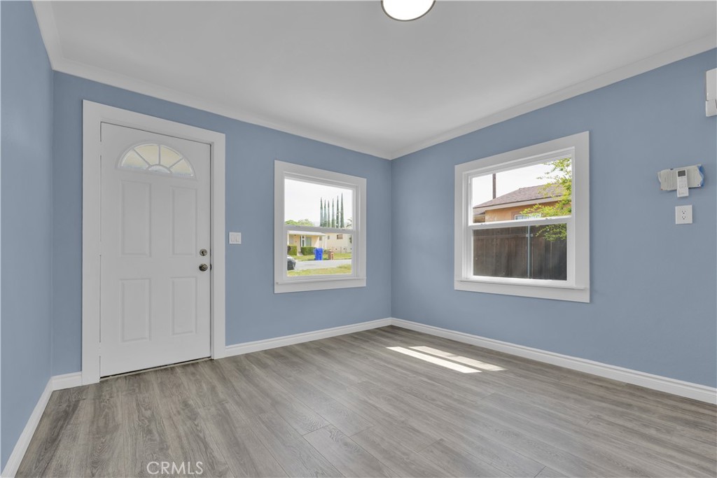 34945 Ave B Yucaipa, CA 92399 - Photo 20 of 69 a view of an empty room with wooden floor and a window