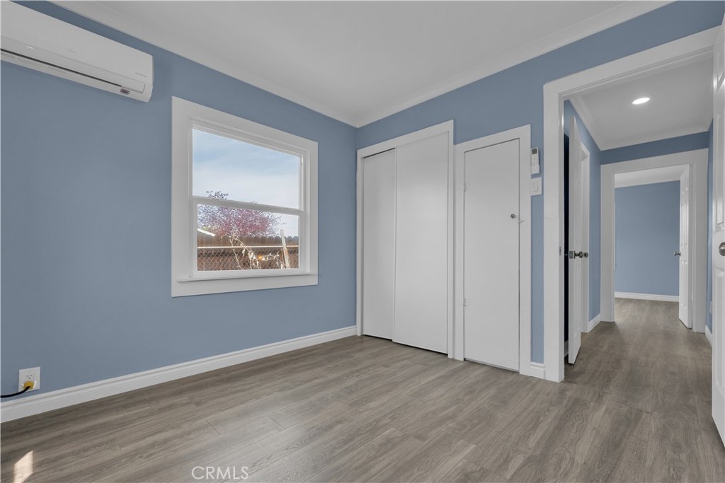 34945 Ave B Yucaipa, CA 92399 - Photo 22 of 69 a view of an empty room with wooden floor and a window
