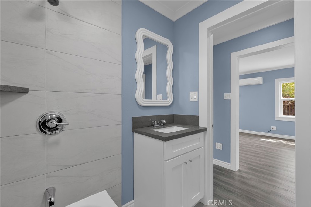 34945 Ave B Yucaipa, CA 92399 - Photo 26 of 69 a bathroom with a granite countertop sink a mirror and vanity