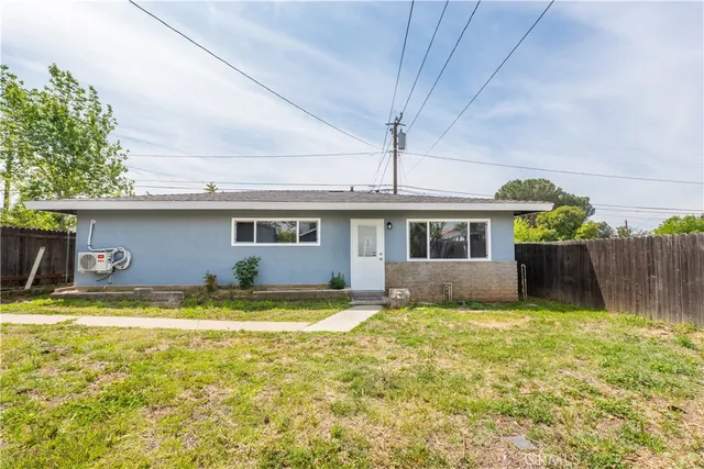 a large kitchen with stainless steel appliances granite countertop a wooden floors and white cabinets