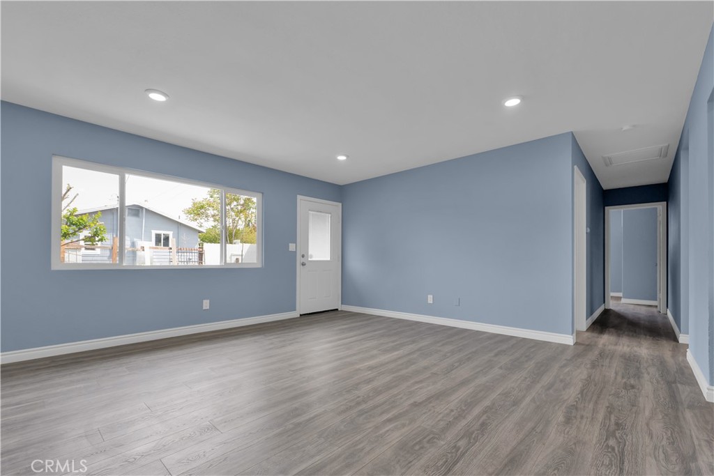34945 Ave B Yucaipa, CA 92399 - Photo 33 of 69 a view of an empty room with wooden floor and a window