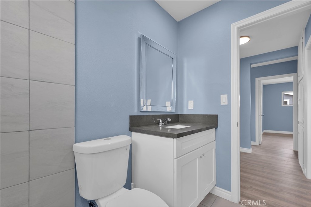 34945 Ave B Yucaipa, CA 92399 - Photo 45 of 69 a bathroom with a granite countertop toilet sink and mirror