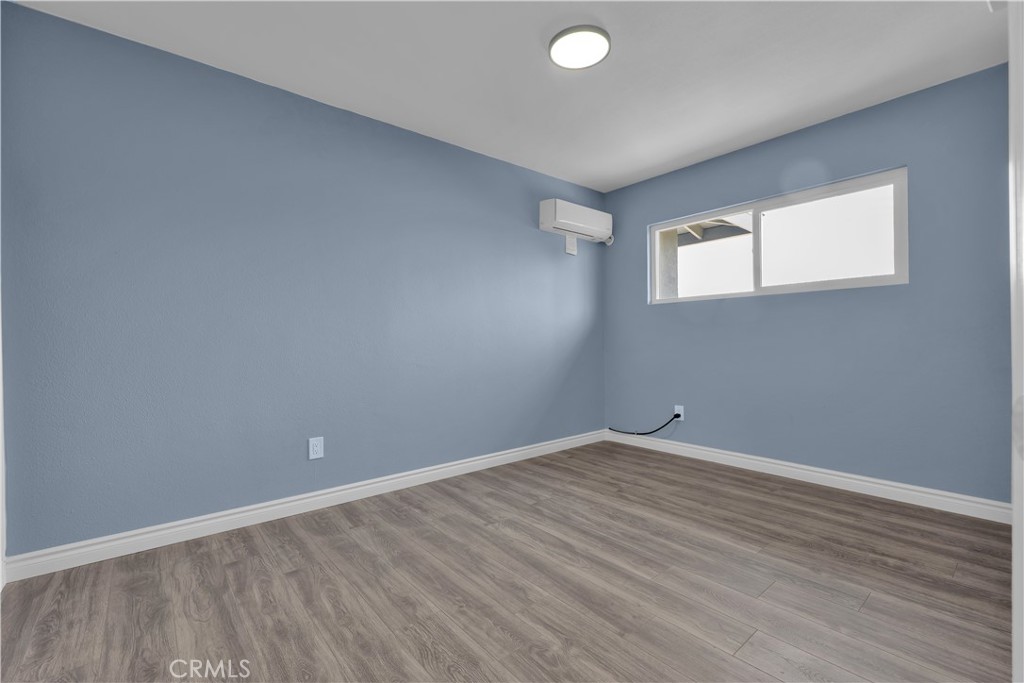 34945 Ave B Yucaipa, CA 92399 - Photo 46 of 69 an empty room with wooden floor and windows