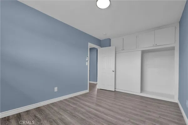 an aerial view of a house with swimming pool and large trees