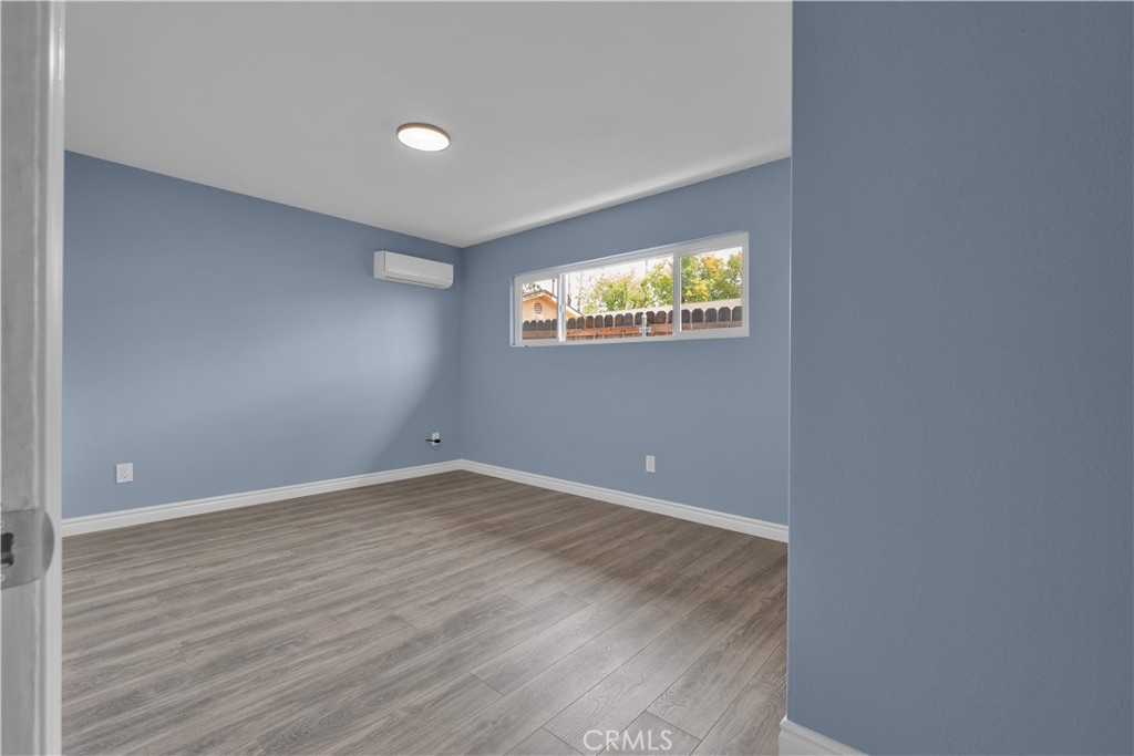 34945 Ave B Yucaipa, CA 92399 - Photo 51 of 69 a view of an empty room with wooden floor and windows