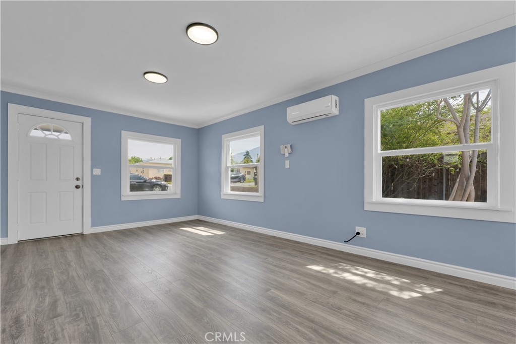 34945 Ave B Yucaipa, CA 92399 - Photo 8 of 69 a view of an empty room with wooden floor and a window