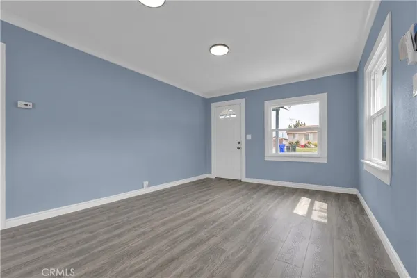 a large kitchen with cabinets and wooden floor