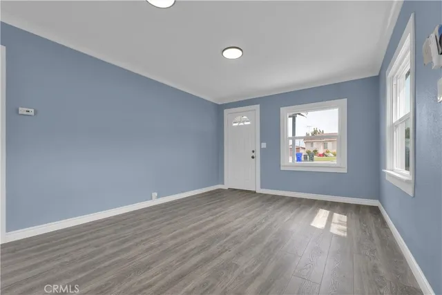 a large kitchen with cabinets and wooden floor