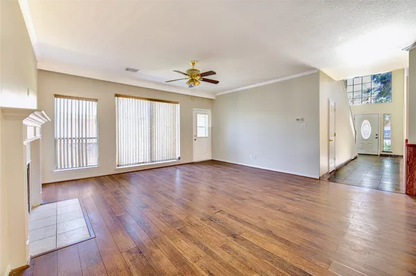 wooden floor in an empty room with a window