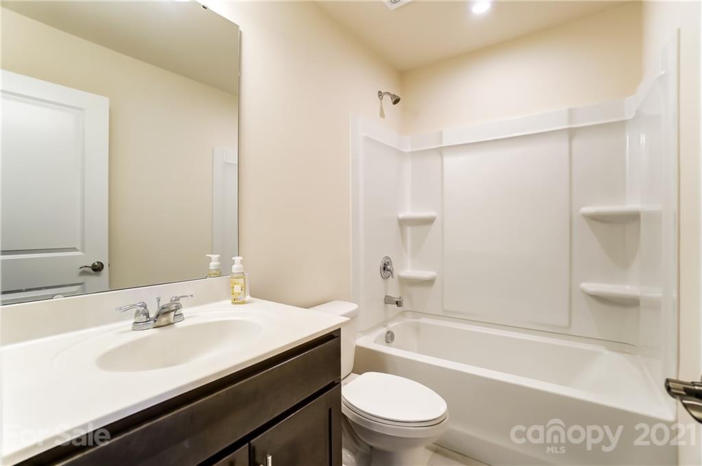 929 Wicawa Road Fort Mill, SC 29708 - Photo 23 of 28 a bathroom with a sink a toilet a mirror and shower