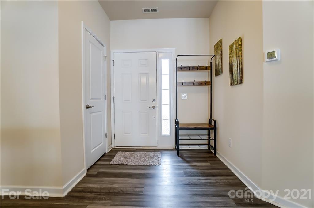 929 Wicawa Road Fort Mill, SC 29708 - Photo 5 of 28 a view of a hallway with wooden floor and staircase