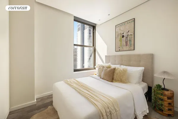 a bedroom with a large bed and a large window