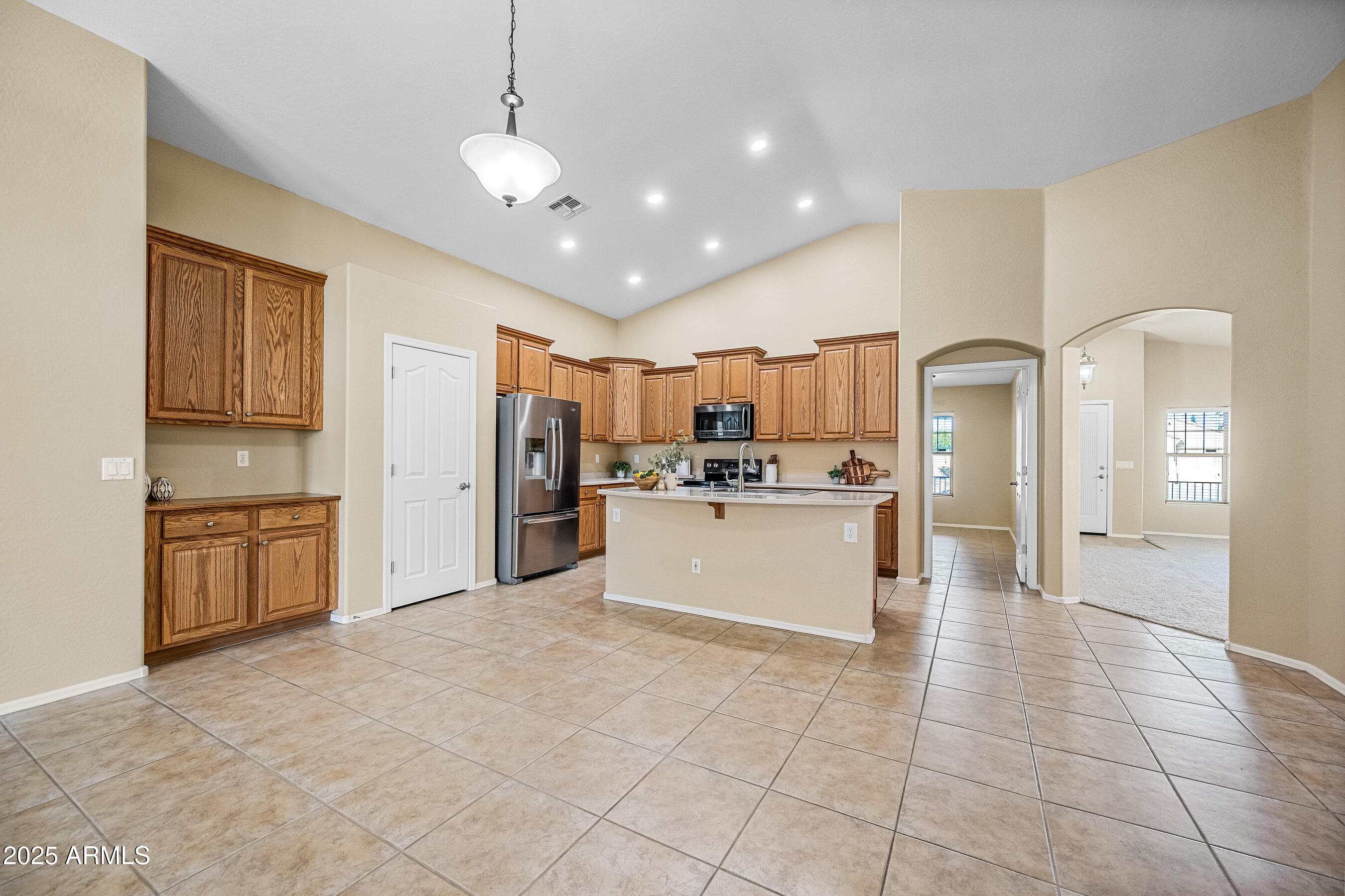 3471 East Fairview Street Gilbert, AZ 85295 - Photo 12 of 48 a large white kitchen with a large window and stainless steel appliances