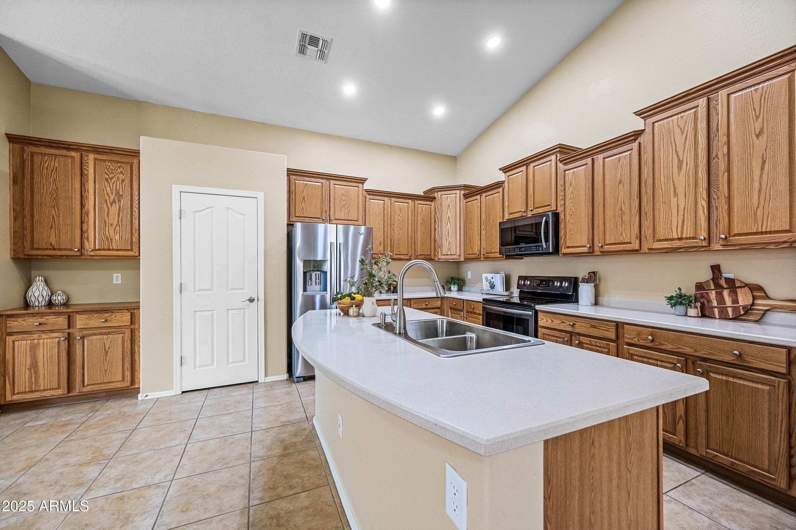 3471 East Fairview Street Gilbert, AZ 85295 - Photo 13 of 48 a kitchen with a sink a stove top oven and cabinets