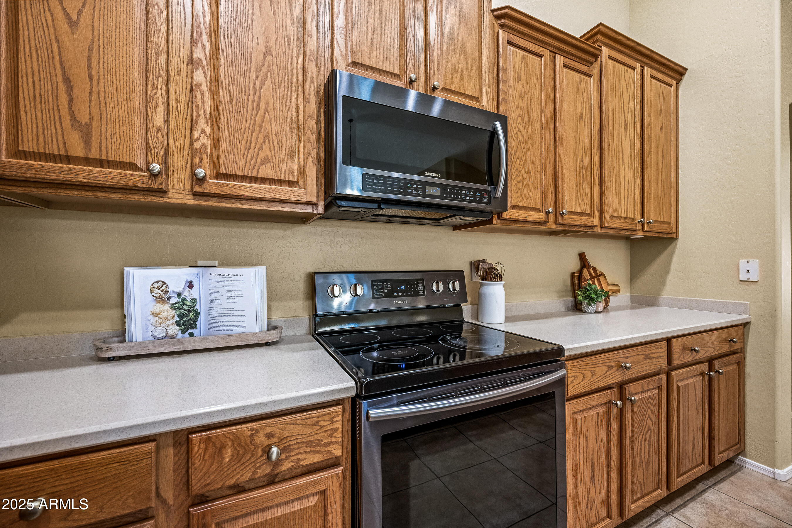 3471 East Fairview Street Gilbert, AZ 85295 - Photo 16 of 48 a kitchen with stainless steel appliances a stove a microwave oven cabinets and a counter top space