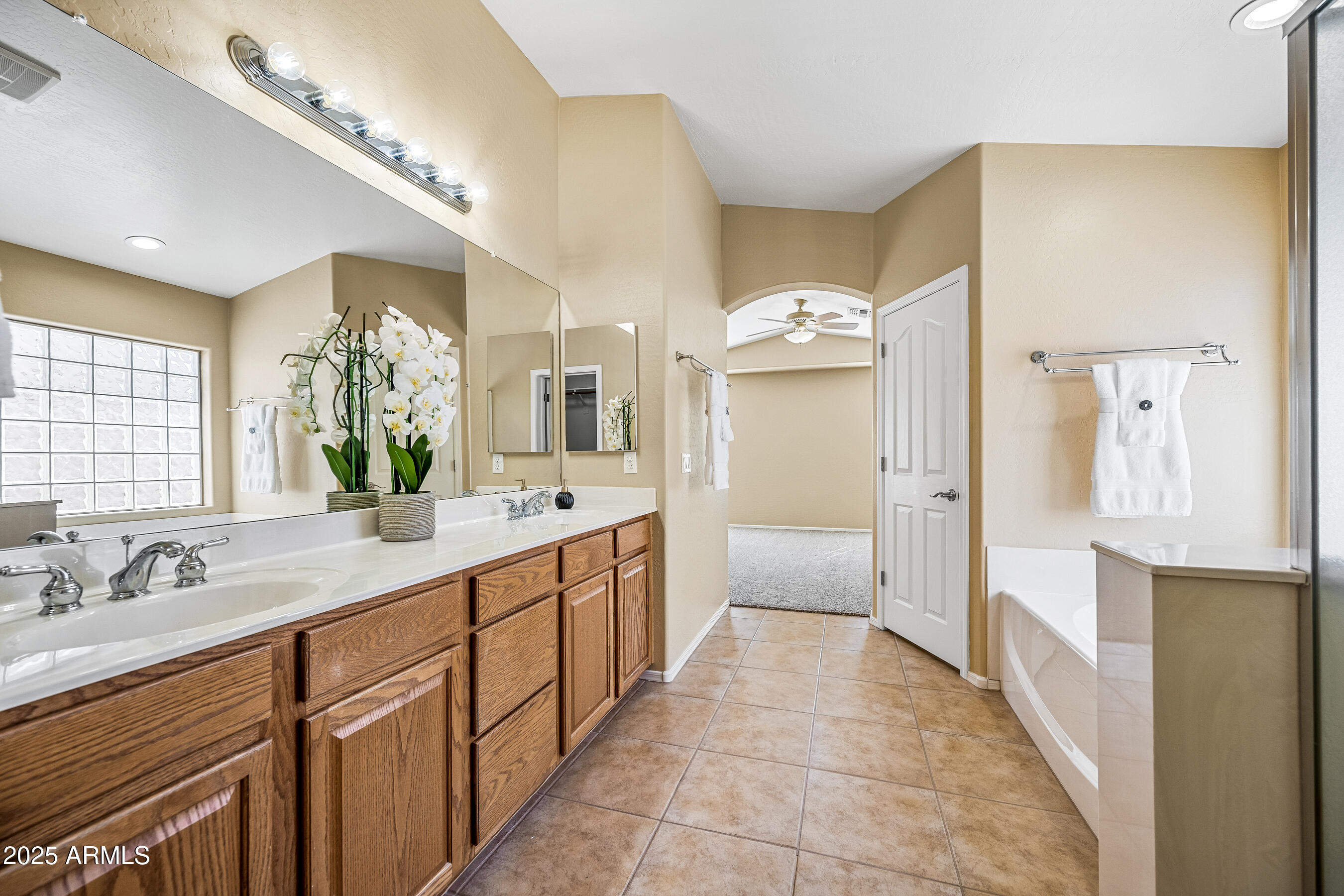 3471 East Fairview Street Gilbert, AZ 85295 - Photo 34 of 48 a large bathroom with a granite countertop sink a large mirror and a shower