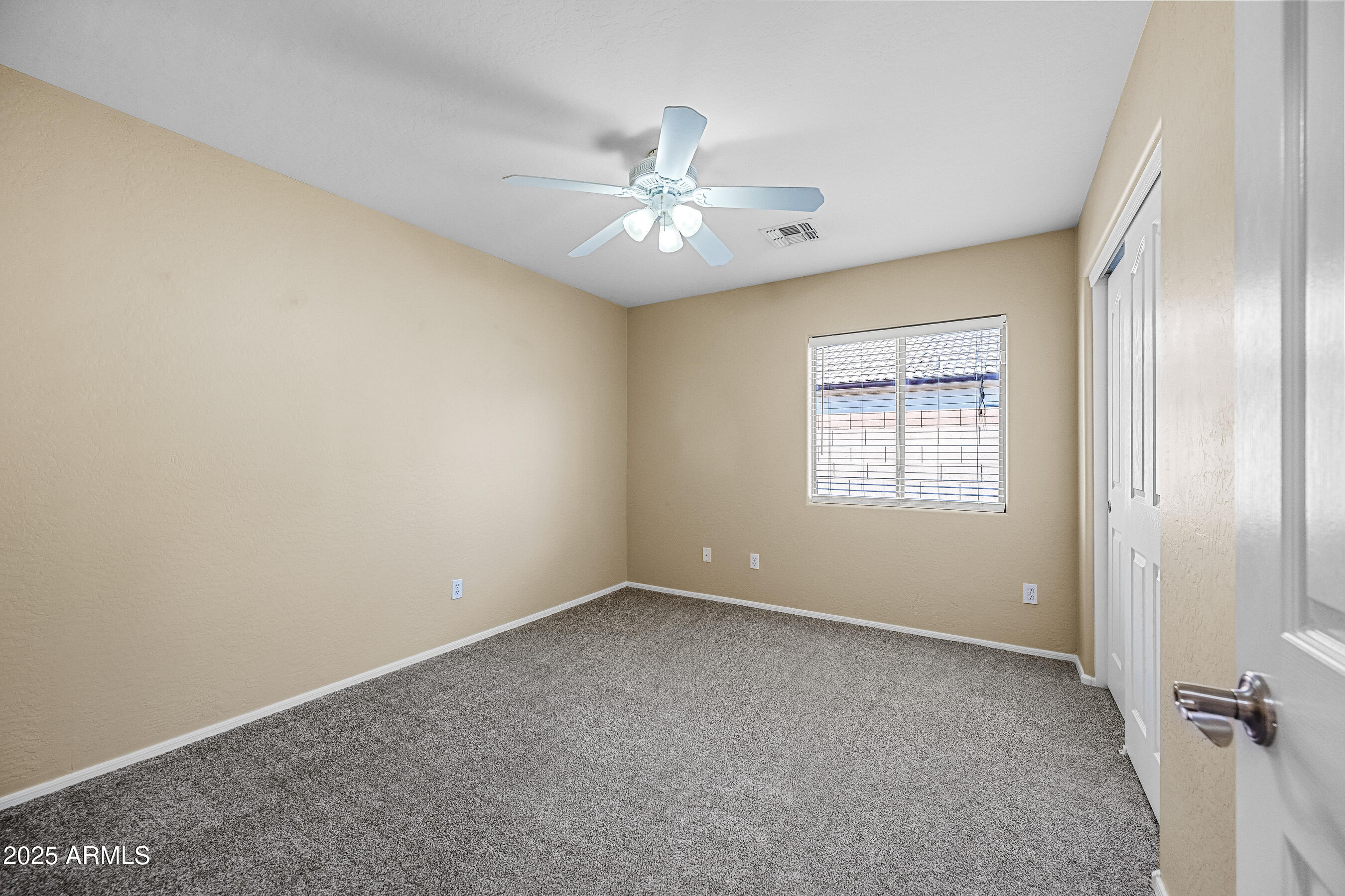 3471 East Fairview Street Gilbert, AZ 85295 - Photo 40 of 48 an empty room with chandelier fan and windows