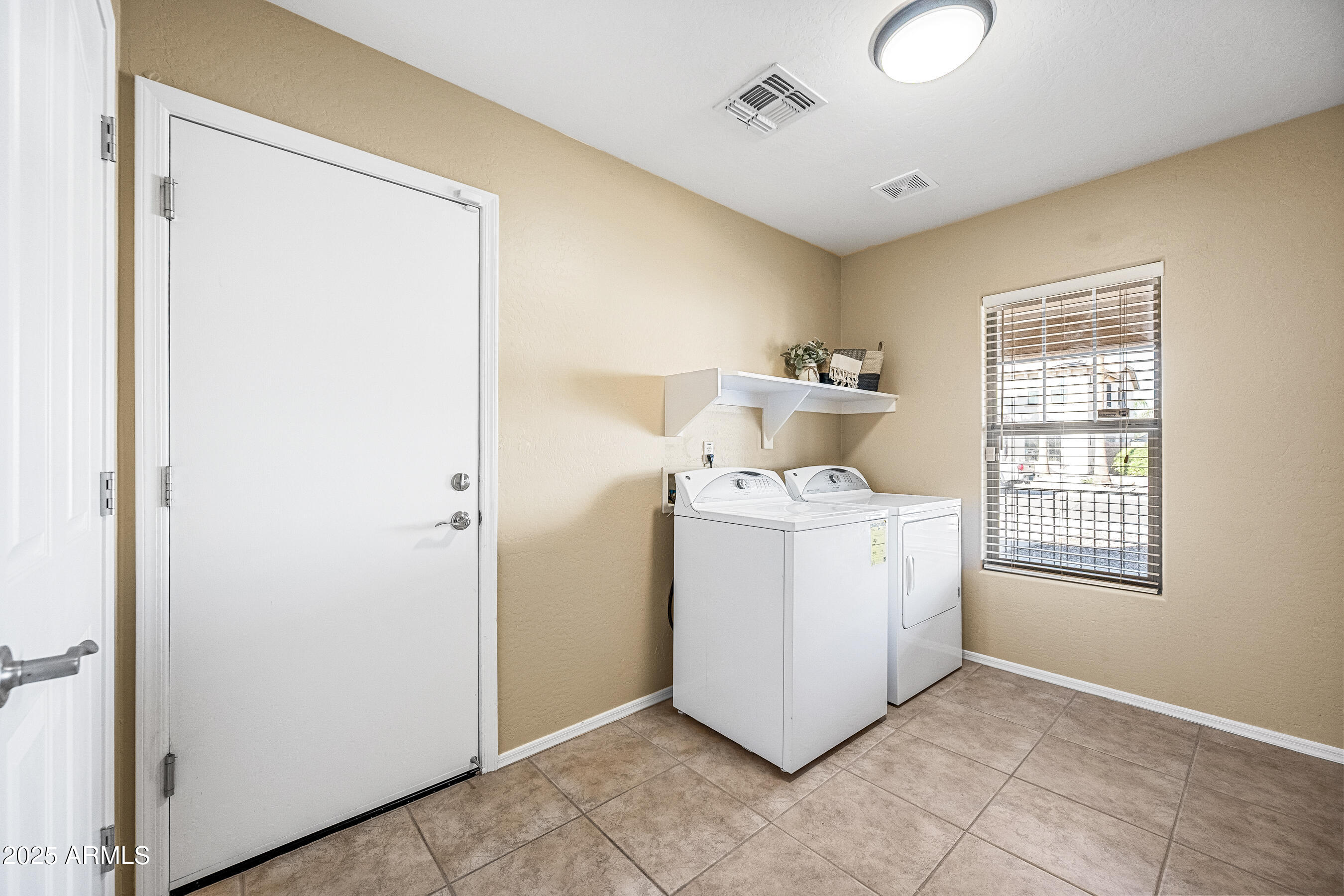 3471 East Fairview Street Gilbert, AZ 85295 - Photo 42 of 48 a utility room with a window dryer and washer