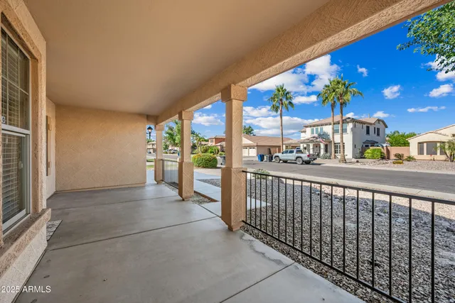 an empty room with windows and chandelier fan