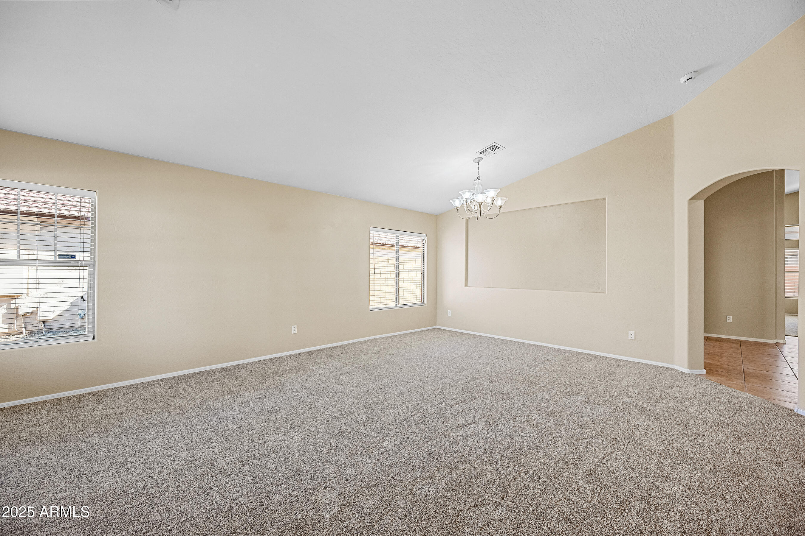 3471 East Fairview Street Gilbert, AZ 85295 - Photo 6 of 48 an empty room with windows and chandelier fan