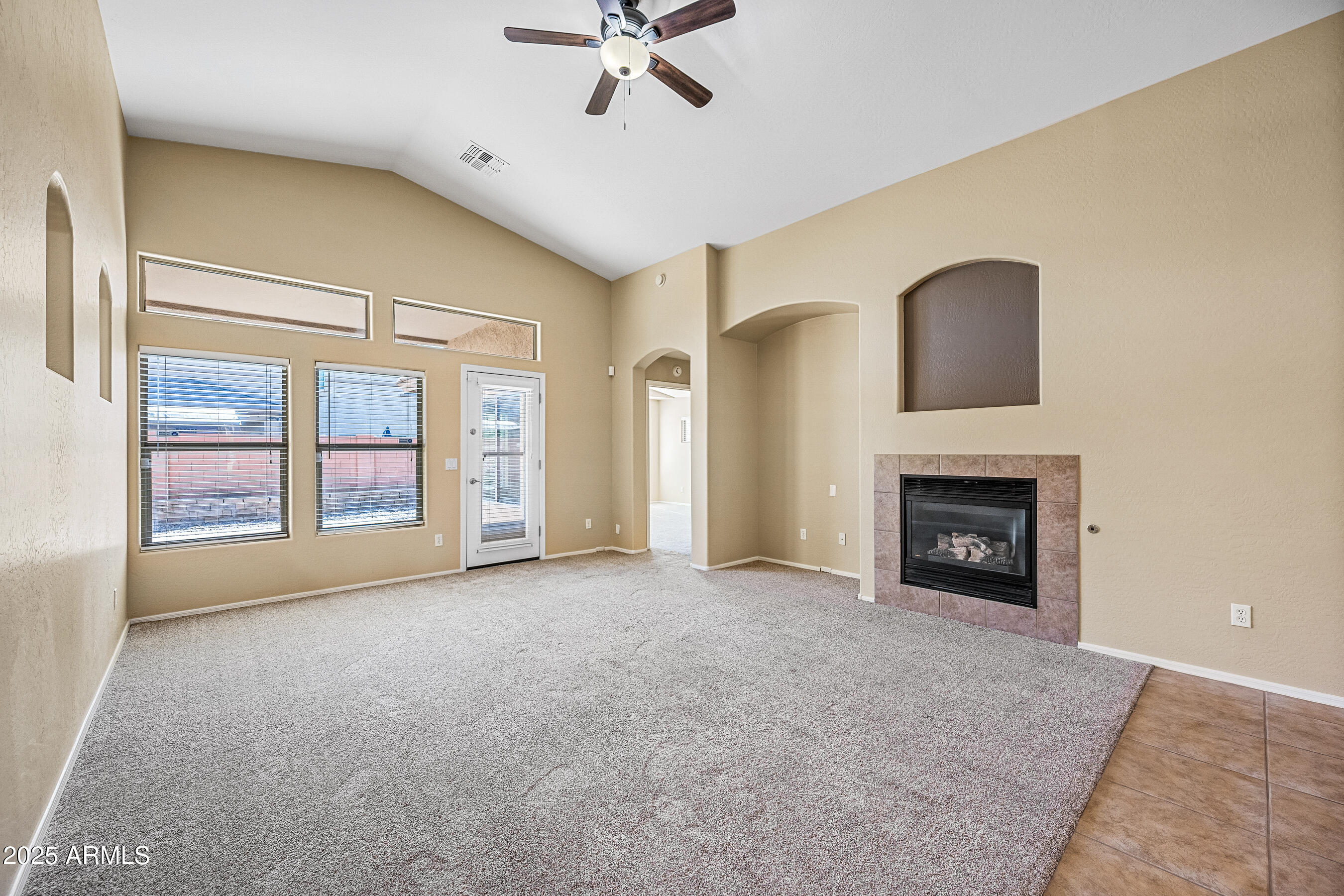3471 East Fairview Street Gilbert, AZ 85295 - Photo 10 of 48 a view of an empty room with a fireplace and a window
