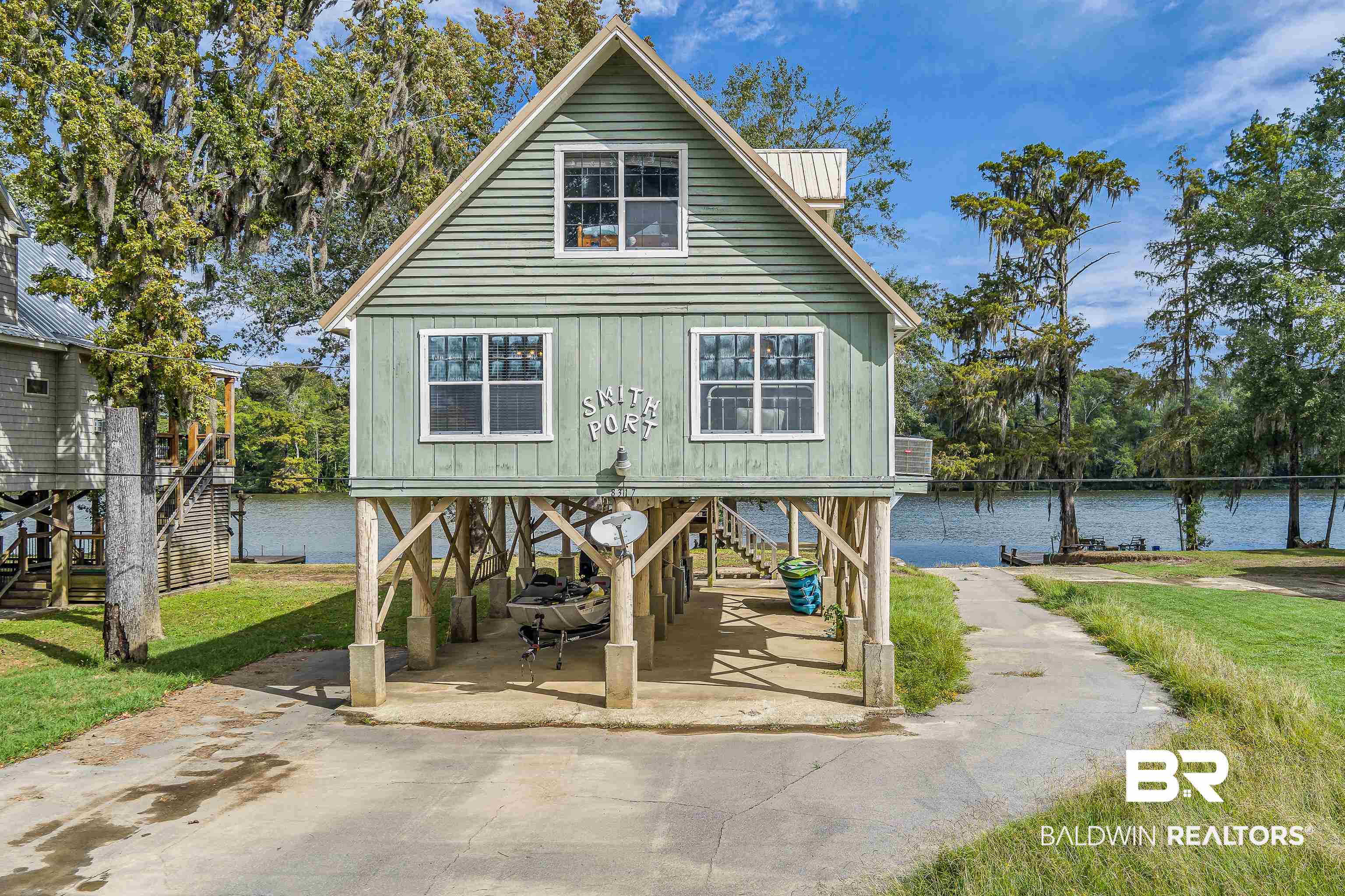 8317 Bryant's Lndg Road Stockton, AL 36579 - Photo 26 of 28 Back of house featuring a water view, stairs, a yard, and a carport