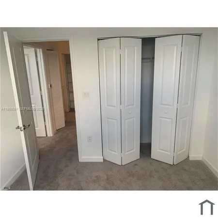 a view of an empty room and a window