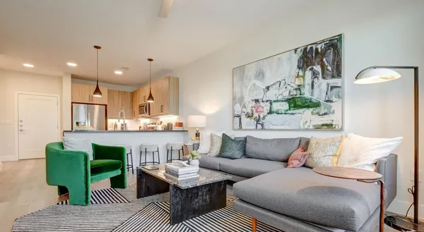 a living room with furniture and a wooden floor