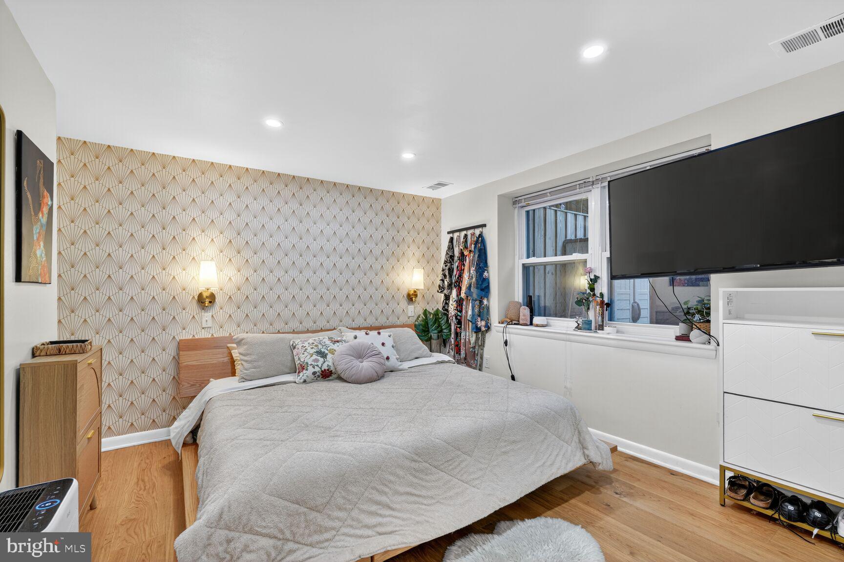 2012 O Street Northwest, Unit 12 Washington, DC 20036 - Photo 11 of 16 a bedroom with a bed and a flat screen tv